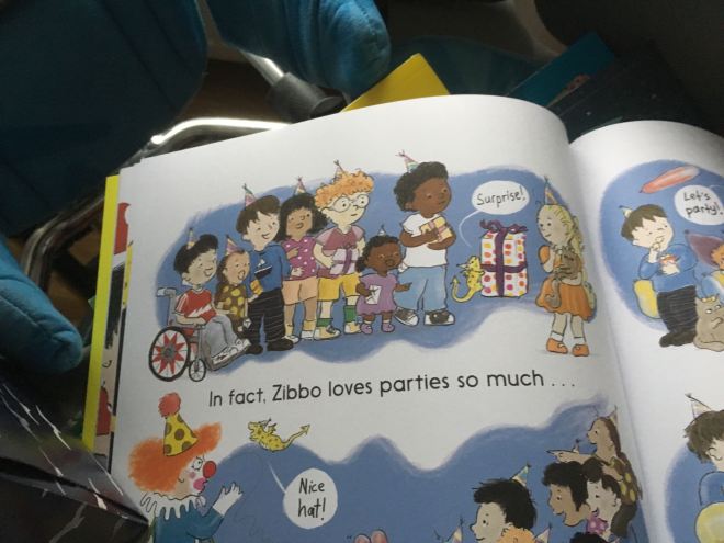 Photo of a page of a children's book with an illustration of children at a birthday party wearing party hats and holding presents.