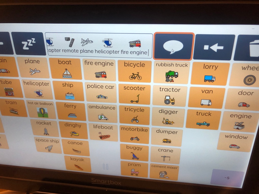 An eye gaze computer grid with symbols and words for vehicles and the words 'remote, plane, helicopter, fire engine' in the speech bar.